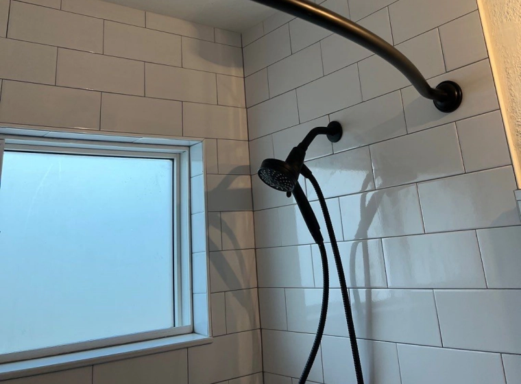 shower room with a black faucet